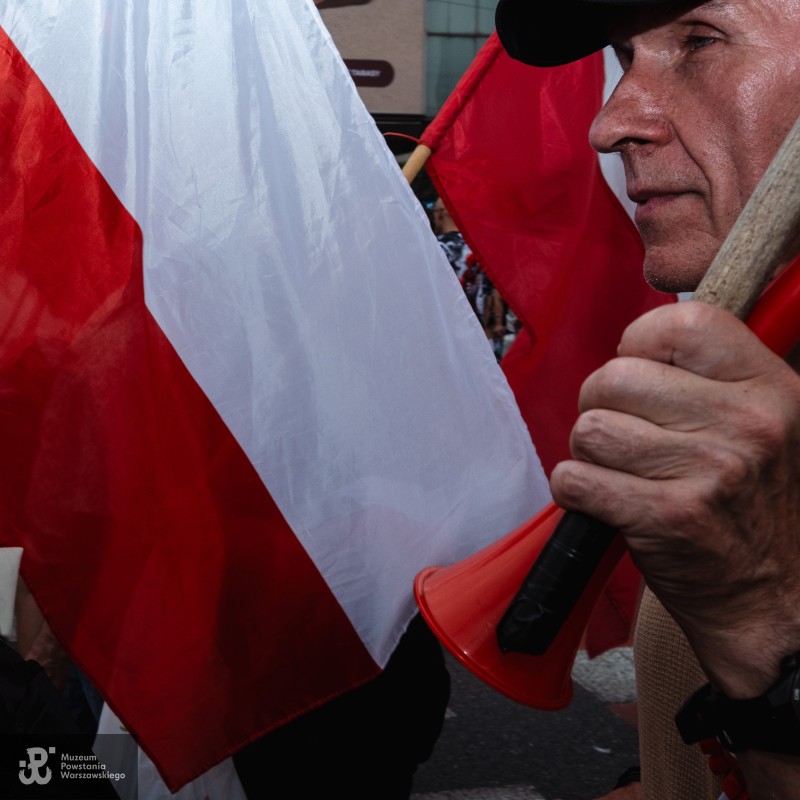 Zbliżenie mężczyzny z flagą i czerwonym megafonem